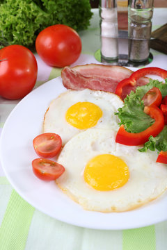 Scrambled eggs with bacon and vegetables served