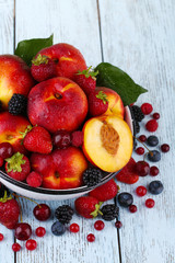 Naklejka na ściany i meble Peaches and berries in bowl on table