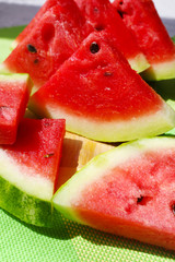 Fresh slices of watermelon on table, outdoors