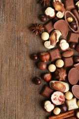 Fototapeta na wymiar Different kinds of chocolates on wooden table close-up