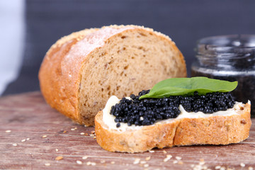 Slices of bread with butter and black caviar