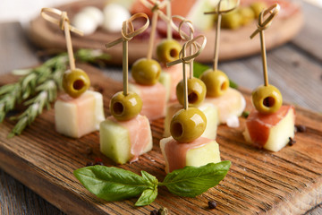 Delicious melon with prosciutto on table close-up