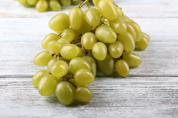 Bunch of ripe grapes on grey wooden background