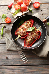 Delicious stuffed peppers in frying pan on table close-up