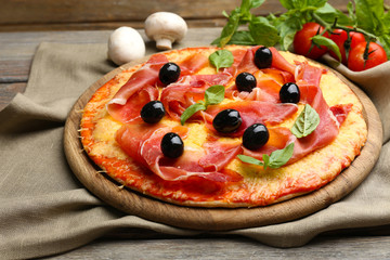 Delicious pizza served on wooden table