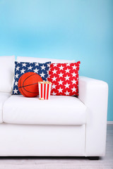 Popcorn and basketball on sofa in room