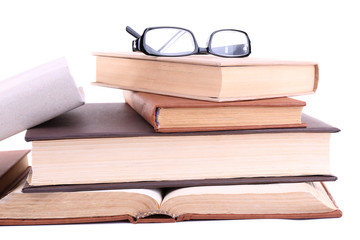 Books in a mess and glasses isolated on white