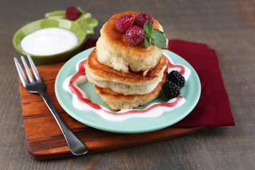 Tasty pancakes with fresh berries and mint leaf