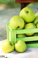 Juicy apples in wooden boxes, outdoors