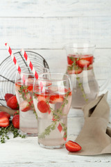 Tasty cool beverage with strawberries and thyme,