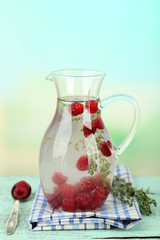 Tasty cool beverage with raspberries and thyme,
