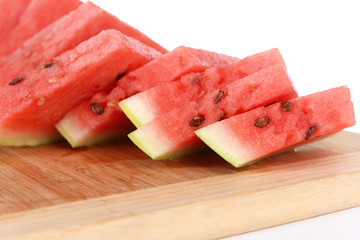 Slices of watermelon on cutting board isolated on white