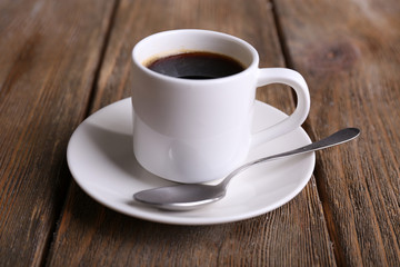 Cup of coffee on wooden background