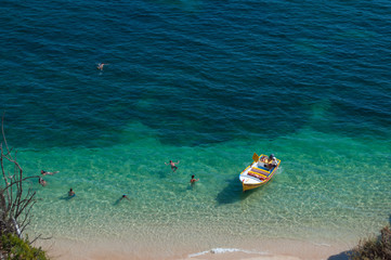Algarve coast, Portugal. People and little boat