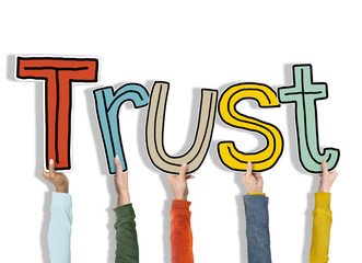 Group of Hands Holding Letter Trust