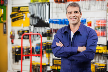 Worker With Arms Crossed In Hardware Shop