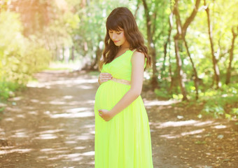 Beautiful pregnant woman in dress in the fabulous forest