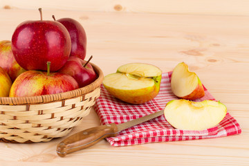 Naklejka na ściany i meble Ripe apples with knife on wooden table.