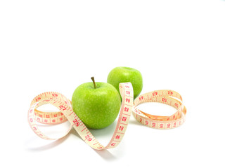 measuring tape wrapped around a green apple for diet