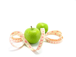 measuring tape wrapped around a green apple for diet