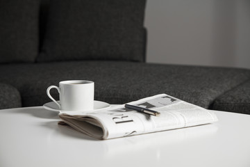Coffee cup and newspaper