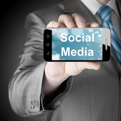 business man hand holding smartphone with Socail Media