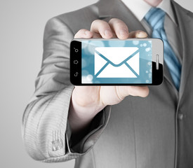 A man holding smartphone with one new message on a screen.
