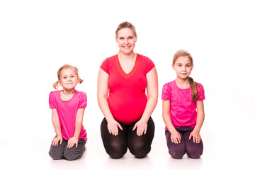 Obraz na płótnie Canvas Pregnant woman with kids exercising isolated