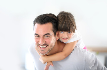 Obraz premium Daddy carrying little girl on his back