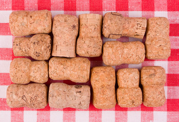 Champaigne corks on a red-white vichy background