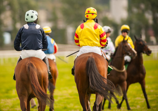 horse riders on the race track