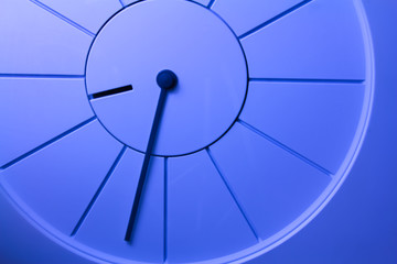 Closeup photo of a blue simple clock.