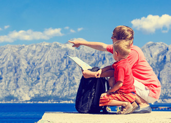 family looking at map on mountains vacation