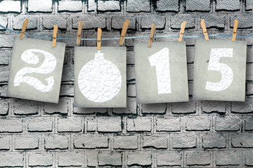 Snow-covered paper numbers of new 2015 with snow on abstract bac
