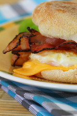 Muffin with fried egg, bacon and cheese