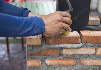 the worker is masoning the brick