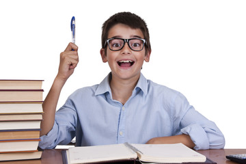 child at the table with books from school