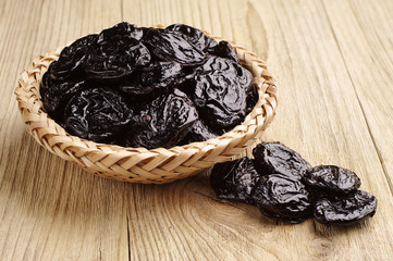 Prunes in wicker bowl