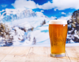 glass of beer over winter landscape