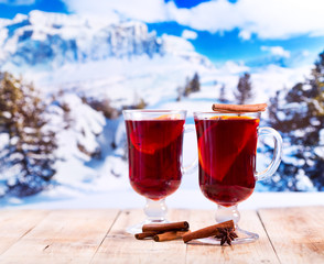 glasses of mulled wine over winter landscape