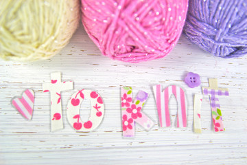 'Love to knit' yarn nd letters on distressed wooden background