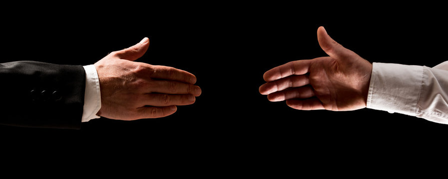 Two men reaching out to shake hands