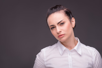 Serious woman wearing white blouse