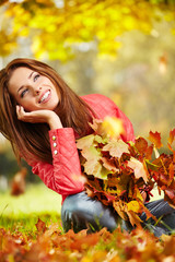 Naklejka na ściany i meble Beautiful woman in autumn park