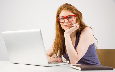 Pretty redhead working on laptop