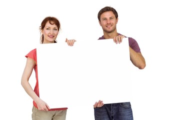 Fototapeta premium Couple holding a white sign