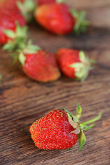 Ripe strawberry on wooden background