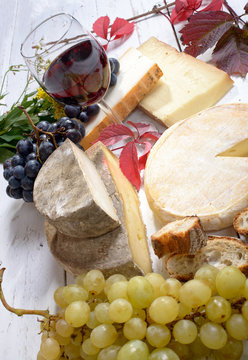 french cheese platter with wine and grapes