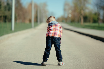 little boy stay back on the street