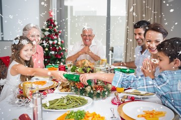 Cheerful family at dining table for christmas dinner